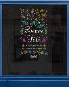 Peinture sur vitrine dans un style végétal avec le message "bonne fête à tous les gens que vous aimez" . Design par Camille F créations