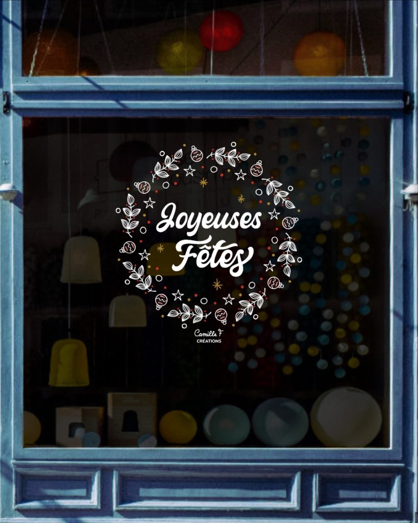 Peinture sur vitrine pour Noël représentant une couronne de feuillage avec le lettrage Joyeuses Fêtes