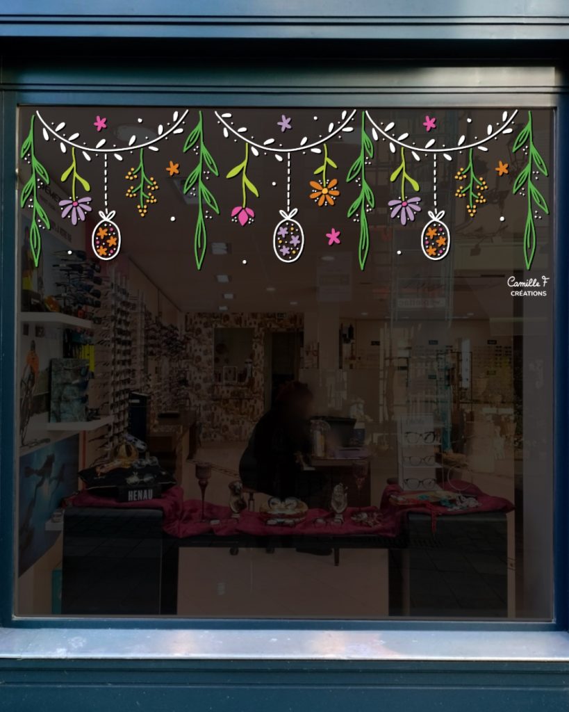Peinture sur vitrine représentant une guirlande végétale sur le thème de Pâques. Décor par Camille F créations