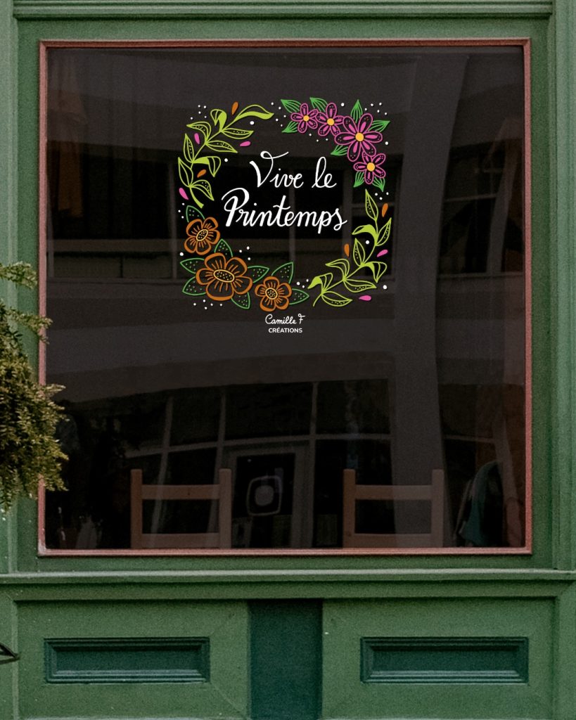 Peinture sur vitrine représentant une couronne végétale et fleurie avec le slogan "vive le printemps". Design par Camille F créations
