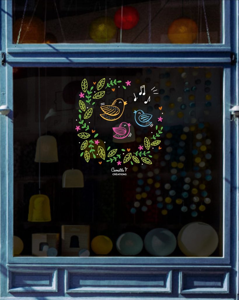 Peinture sur vitrine représentant une couronne végétale de feuillages avec des oiseaux pour le printemps. Design par Camille F créations