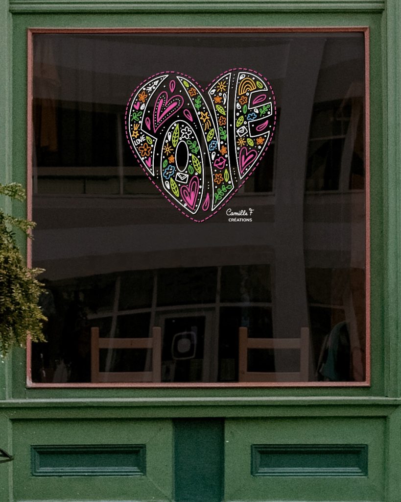 Peinture sur vitrine représentant le mot LOVE en forme de cœur. Design par Camille F créations