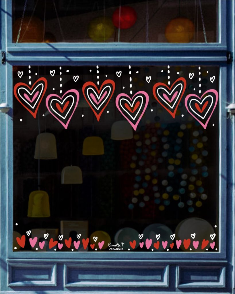 Peinture sur vitrine représentant une multitude de cœurs roses et rouges. Design par Camille F créations