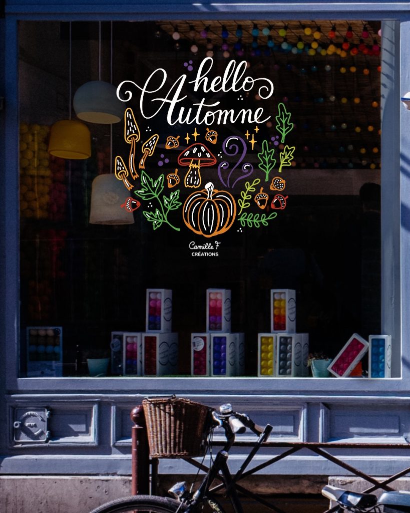 Peinture vitrine sur le thème de l'automne, lettrage "hello automne" avec décor de citrouille, champignons et feuilles
